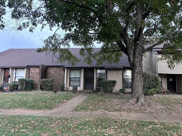 ranch-style home with a front lawn