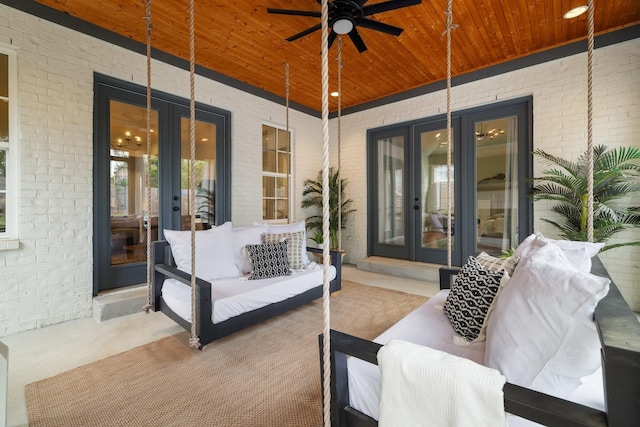 view of patio with ceiling fan, covered porch, and french doors