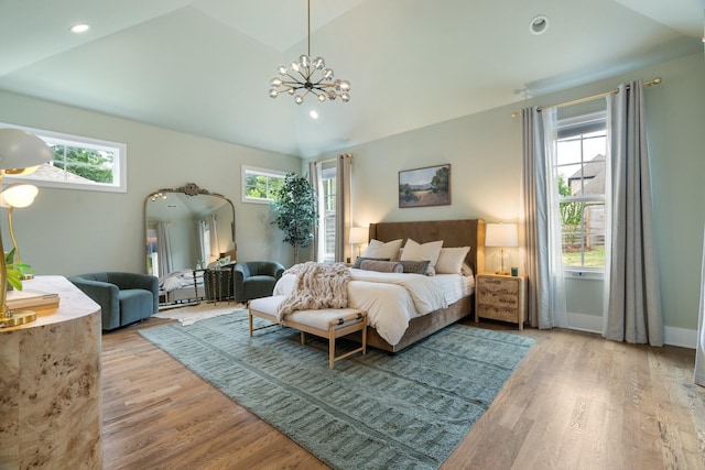 bedroom with lofted ceiling, light hardwood / wood-style flooring, and multiple windows