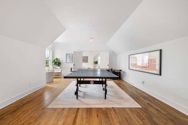 playroom with vaulted ceiling and light wood-type flooring