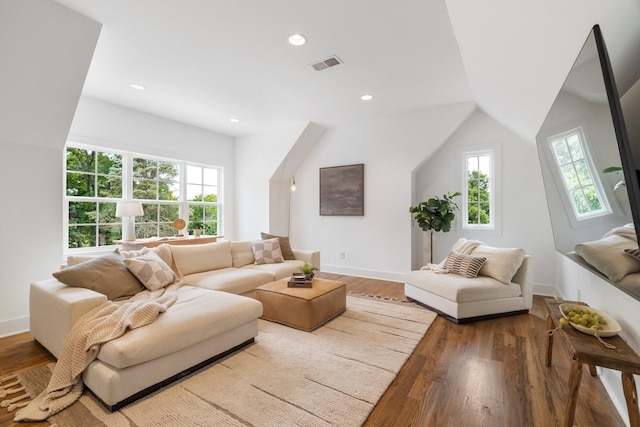 living room featuring wood-type flooring and lofted ceiling