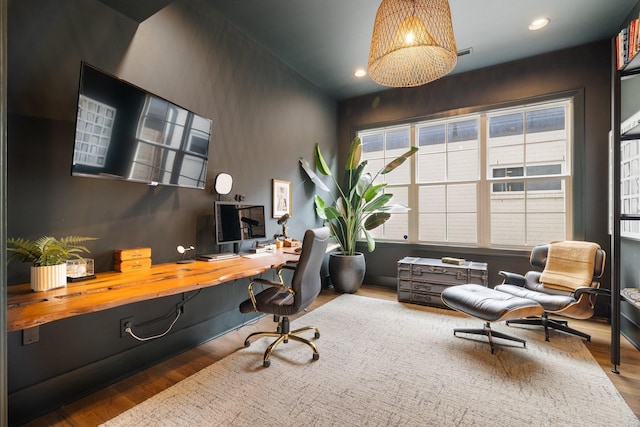 office featuring built in desk and wood-type flooring