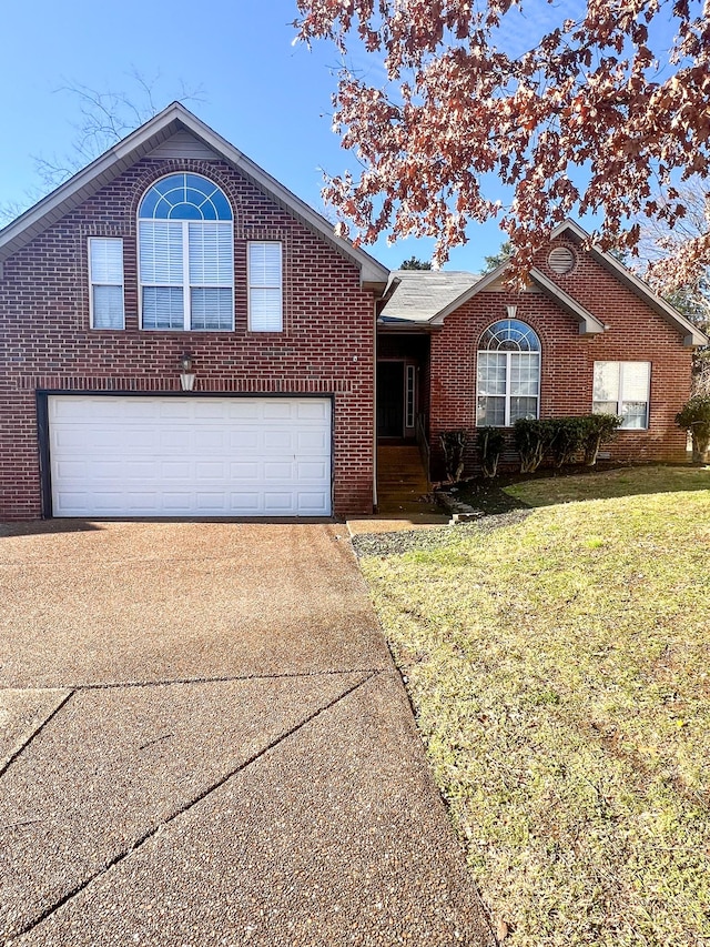 view of front of house featuring a front yard and a garage