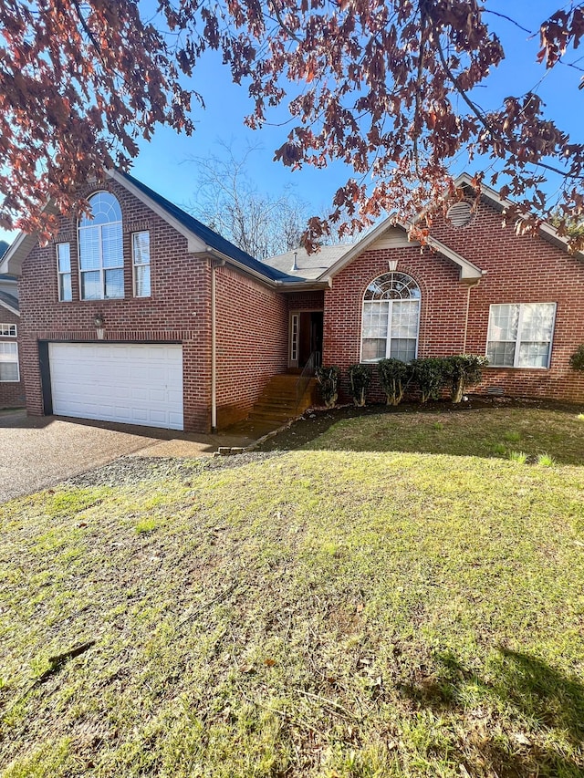 view of front of property featuring a front yard and a garage