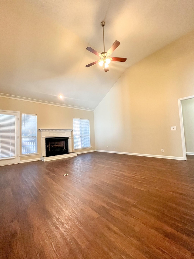 unfurnished living room with dark hardwood / wood-style flooring, ceiling fan, plenty of natural light, and vaulted ceiling