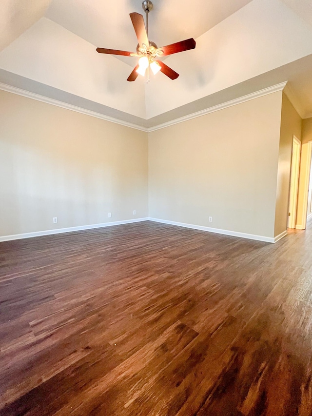 unfurnished room featuring dark hardwood / wood-style floors, ceiling fan, a raised ceiling, and crown molding