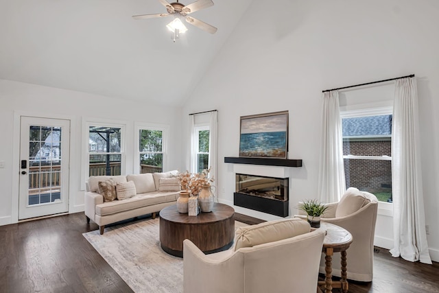 living room with dark hardwood / wood-style floors, ceiling fan, and high vaulted ceiling