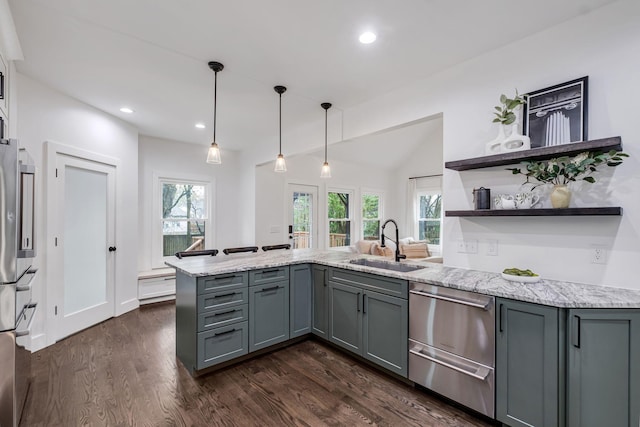 kitchen featuring kitchen peninsula, sink, gray cabinets, dark hardwood / wood-style floors, and hanging light fixtures