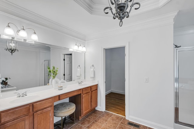 bathroom featuring a chandelier, vanity, an enclosed shower, and crown molding