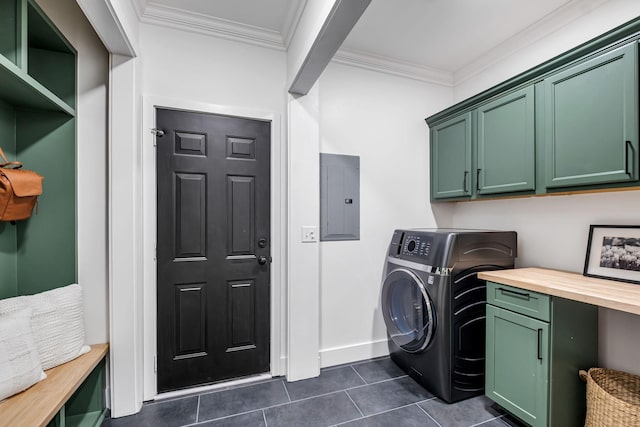 washroom with cabinets, ornamental molding, dark tile patterned floors, washer / clothes dryer, and electric panel