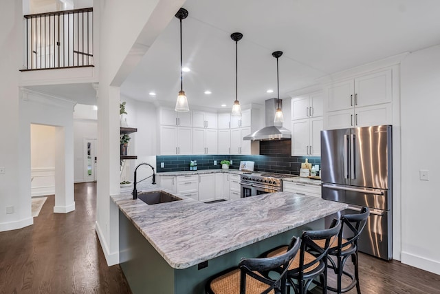 kitchen with white cabinets, sink, wall chimney exhaust hood, and appliances with stainless steel finishes