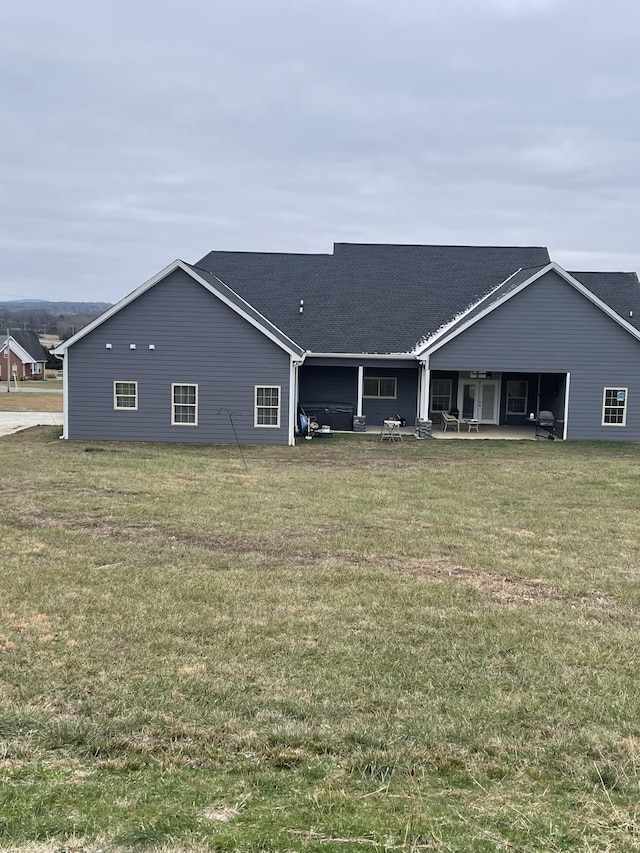 back of house featuring a patio area and a yard