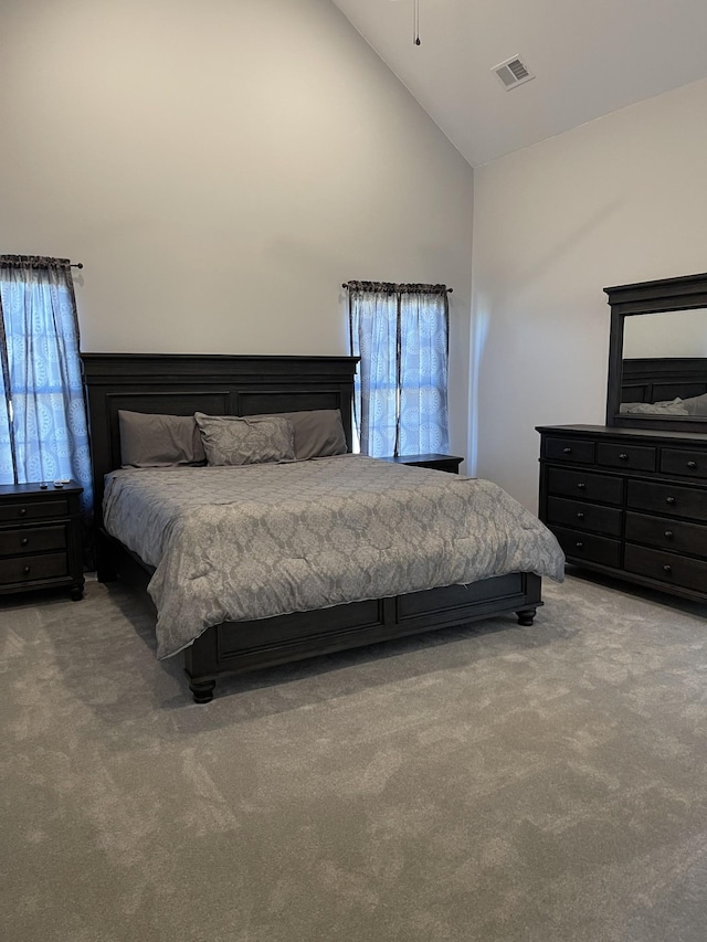 bedroom featuring carpet flooring and high vaulted ceiling