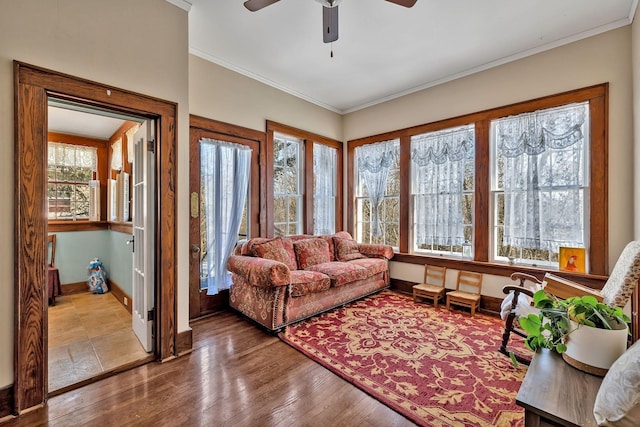 living room featuring hardwood / wood-style flooring, crown molding, and a healthy amount of sunlight