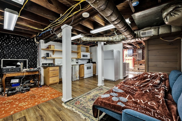 basement with dark hardwood / wood-style floors, white refrigerator, and electric panel