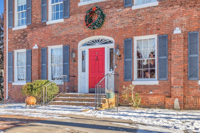 view of snow covered property entrance