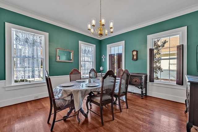 dining space featuring a chandelier, a wealth of natural light, and ornamental molding