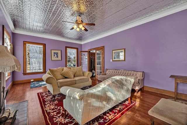 living room with ceiling fan, ornamental molding, dark wood-type flooring, and french doors