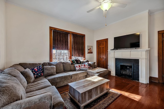 living room with ceiling fan, dark wood-type flooring, and a brick fireplace