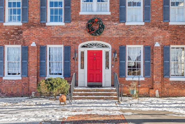 view of snow covered property entrance