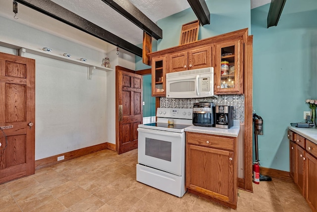 kitchen with backsplash, beam ceiling, and white appliances