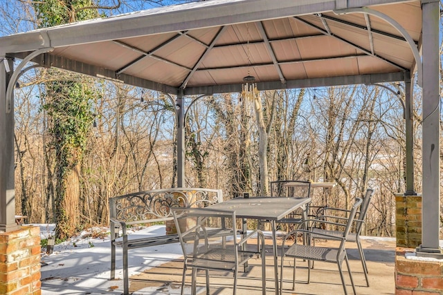 wooden terrace with a gazebo and a patio area