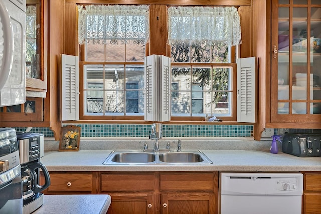 kitchen featuring white appliances and sink