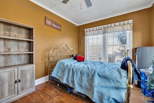 bedroom with ceiling fan, dark hardwood / wood-style flooring, and ornamental molding