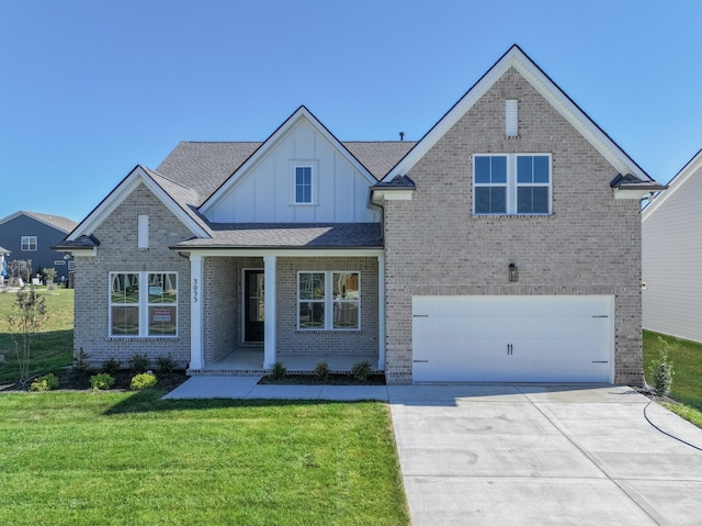 view of front of property featuring covered porch, a garage, and a front yard