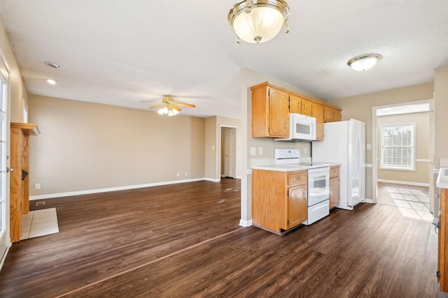 kitchen with a textured ceiling, white appliances, ceiling fan, and dark wood-type flooring