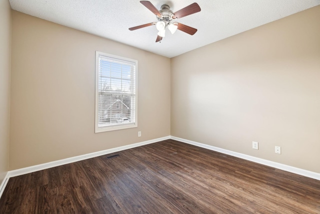 unfurnished room with ceiling fan, dark hardwood / wood-style flooring, and a textured ceiling