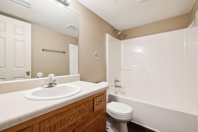 full bathroom featuring vanity, toilet, shower / tub combination, and a textured ceiling