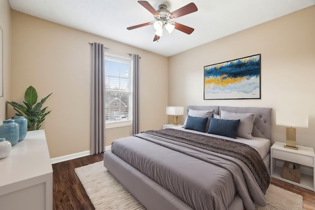 bedroom with dark hardwood / wood-style flooring and ceiling fan