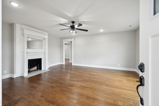 unfurnished living room featuring a fireplace, hardwood / wood-style flooring, and ceiling fan