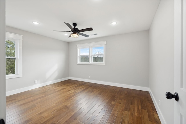 empty room with hardwood / wood-style floors and ceiling fan