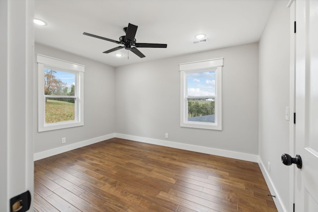 spare room with ceiling fan and dark wood-type flooring