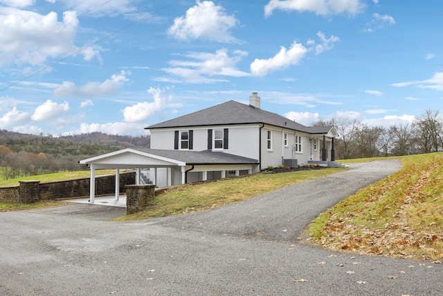 view of home's exterior with a carport