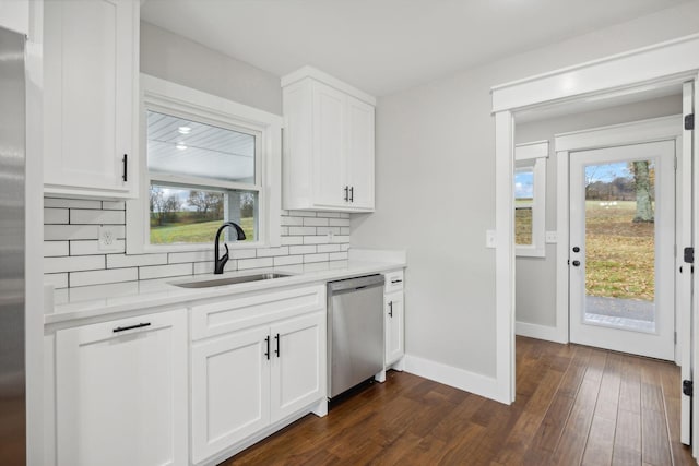 kitchen with backsplash, dark wood-type flooring, sink, appliances with stainless steel finishes, and white cabinetry