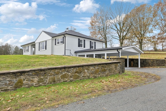 view of home's exterior featuring a yard and a carport