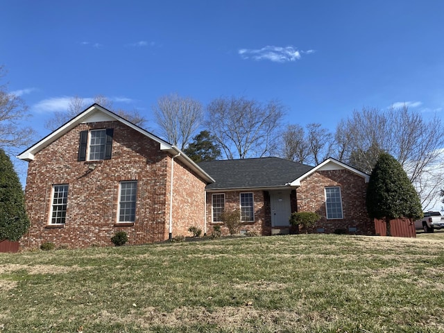 view of front of property featuring crawl space, brick siding, roof with shingles, and a front lawn