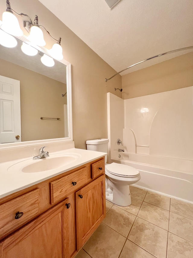 full bathroom featuring tile patterned flooring, a textured ceiling, toilet, shower / washtub combination, and vanity