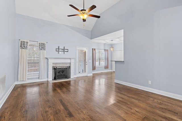 unfurnished living room with ceiling fan, high vaulted ceiling, and dark hardwood / wood-style floors