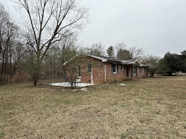 view of home's exterior with a lawn and a patio