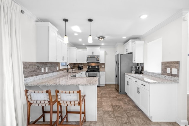 kitchen with white cabinets, sink, decorative light fixtures, kitchen peninsula, and stainless steel appliances