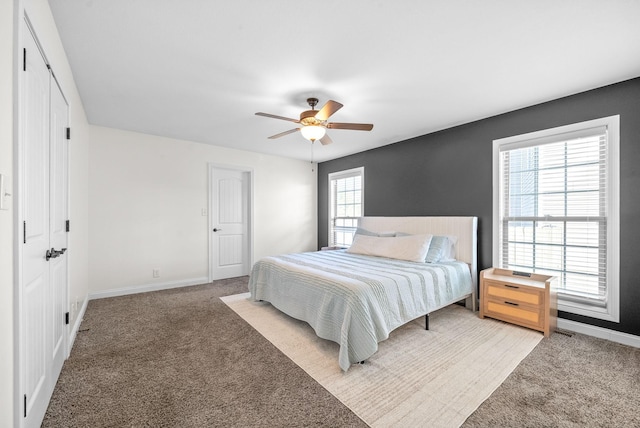 bedroom featuring ceiling fan and carpet