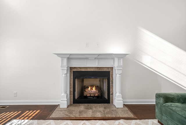 interior details featuring a fireplace and hardwood / wood-style floors