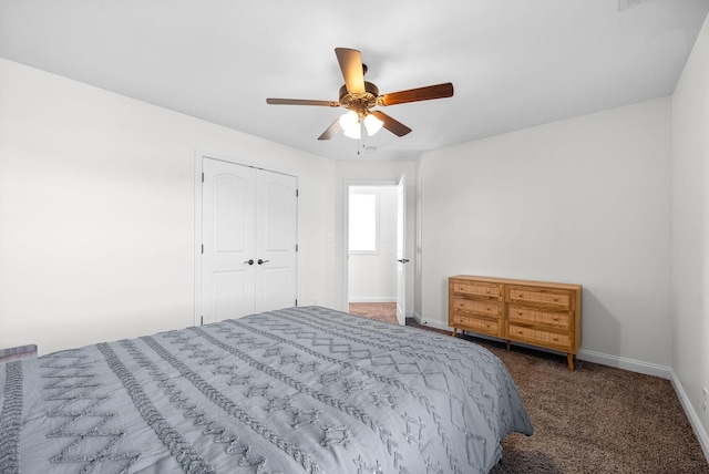 bedroom featuring a closet, dark carpet, and ceiling fan