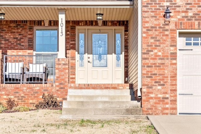 doorway to property with a garage