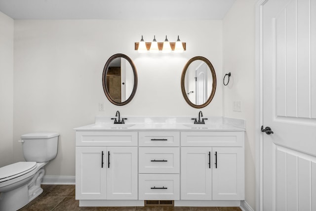 bathroom featuring tile patterned flooring, vanity, and toilet