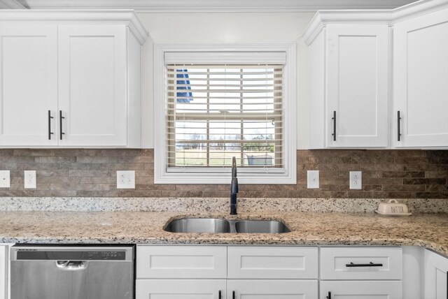 kitchen featuring white cabinets, dishwasher, and sink